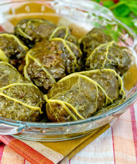Rhubarb leaves stuffed in glass pan on towel