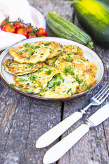 Squash and zucchini fritters on old wooden table