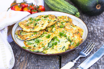 Squash and zucchini fritters on old wooden table