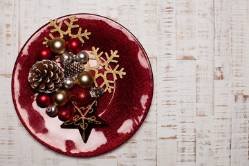 Plate on rustic wooden background. Christmas table setting concept