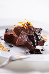 Homemade tasty delicious christmas dessert on a plate in restaurant - brownie with caramel and chocolate sauce