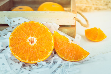 Naklejka na ściany i meble Oranges, close up whole orange fruits and sliced orange on wood