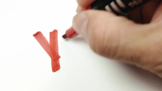 The word No written on a blank paper sheet; a hand rips it and draws a Yes instead, with a red felt tip pen - marker. Macro shot.
