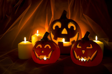Spooky Halloween scene with Jack-o-Lanterns and candles glowing on a mysterious background