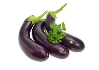 Three eggplants and parsley sprigs on a light background