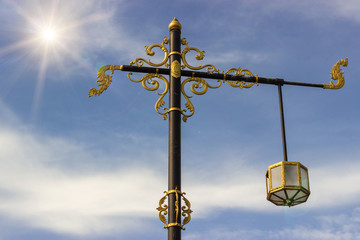 Fototapeta na wymiar electric pole with a gold filigree architecture.