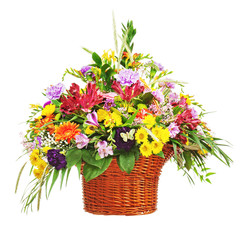 Flower bouquet arrangement centerpiece in wicker basket isolated on white background. Closeup.