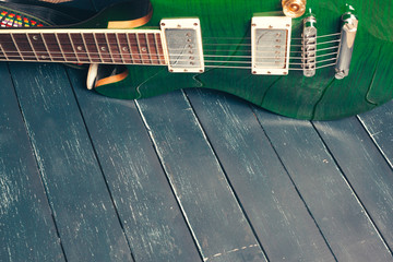 Electric guitar body and neck detail on wooden background