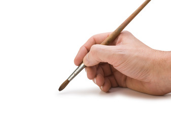 hand holds the brush to draw