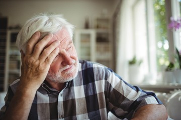 Tensed senior man looking away