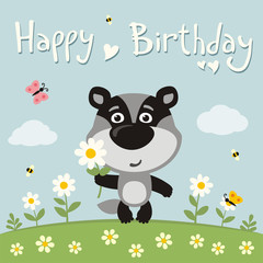 Obraz na płótnie Canvas Happy birthday! Cute badger with flower on meadow. Birthday card.
