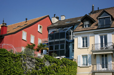 Fototapeta na wymiar Urban houses in Switzerland - roof, window, balcony