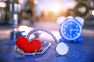 Red heart and Stethoscope on rubber floor in gym Take care of yourself to take time for exercise Concept