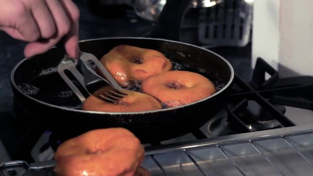 Frying donuts in a kitchen, detail of a kitchen, sweet dessert