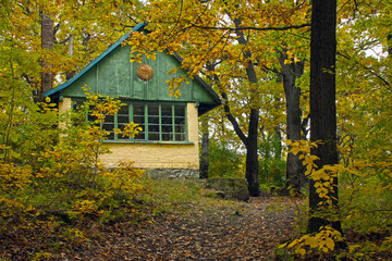 One hundred years old abandoned tourist house in deep forest at autumn