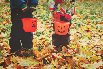 little boy and girl trick or treating in fall nature - obrazy, fototapety, plakaty