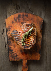 Grilled beef steak with rosemary.Top view with copy space
