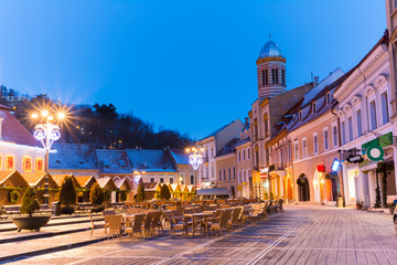 Fototapeta na wymiar Beautiful architecture of Brasov town illuminated in evening light, Christmas time, Romania
