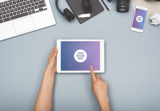 User with Tablet with Smartphone on Blue Background Mockup 