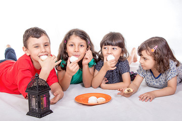 Muslim Children eating Kahk - Kaak ( Cookies ) in the feast