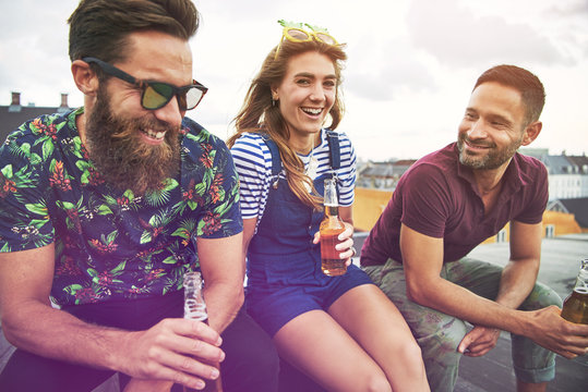 Three young adult friends drinking together - Powered by Adobe