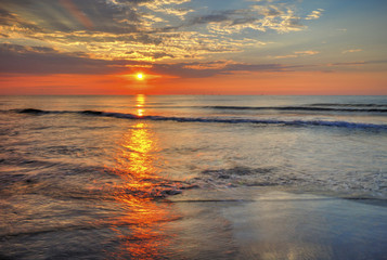 Fototapeta premium Beautiful sunrise over the sea with dramatic clouds on the sky