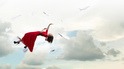 Woman levitating in sky . Mixed media