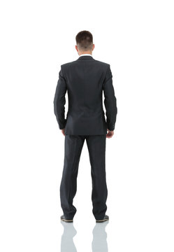 Businessman from the back - looking at something over a white ba