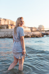 Happy carefree woman dancing at sunset on the beach. Happy free