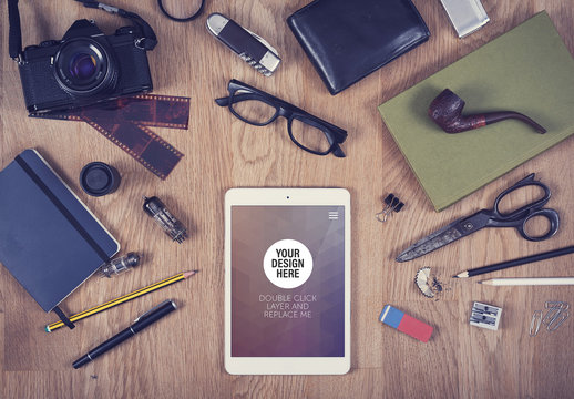 Tablet with Scattered Objects on Wooden Background Mockup 2