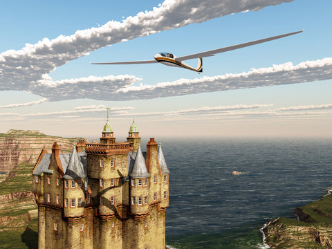 Segelflugzeug und schottisches Schloss am Meer