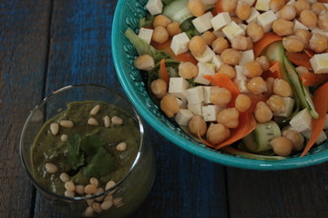 vegan salad with chickpeas, carrot, cucumber, tofu and pesto in a glass