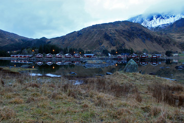 Lofoten Islands - Camping cabins reflected in a lake