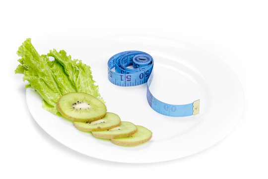healthy eating. measuring tape and fresh kiwi