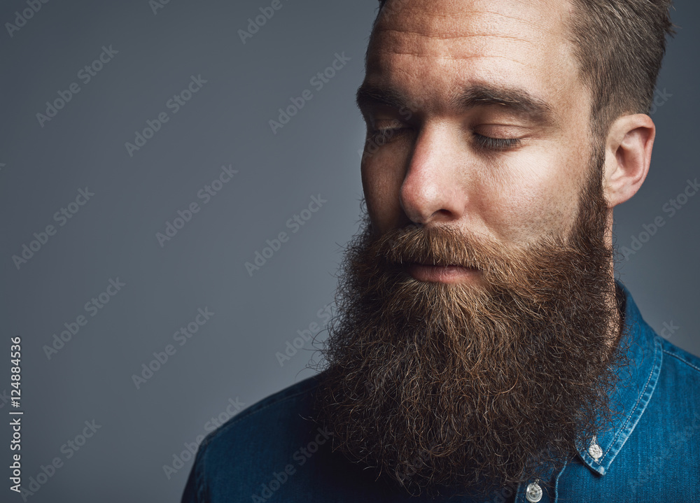 Wall mural Bearded man in blue denim with eyes closed