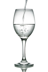 Close up wine glass - pour water into a glass - isolated