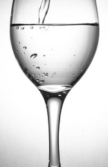 Close up wine glass - pour water into a glass