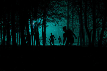 bloodthirsty zombies attacking. hungry zombies in the woods. Silhouettes of scary zombies walking in the forest at night © PT88