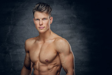 Shirtless sporty male on grey background.