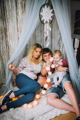 Young, happy family in a room interior