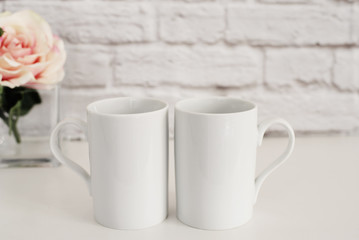 Fototapeta na wymiar Two Mugs. White Mugs Mockup. Blank White Coffee Mug Mock up. Styled Photography. Coffee Cup Product Display.
