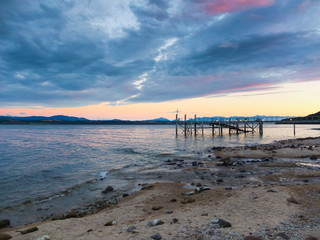 Sand rocky beach in sunset