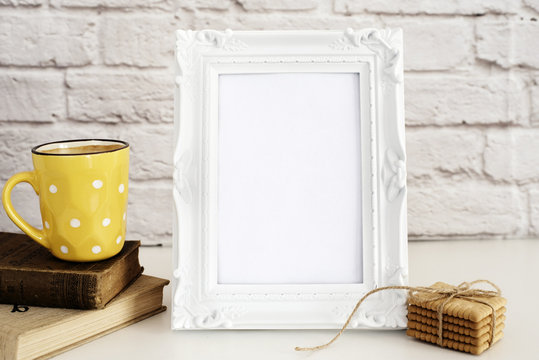 Frame Mockup. White Frame Mock Up. Yellow Cup Of Coffee With White Dots, Cappuccino, Latte, Old Books, Cookies. Display Mock-Up, Styled Stock Photography. Empty Rustic Frame. 