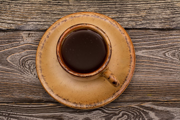 Small cup of coffee on wooden background