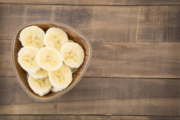Fresh pieces of banana on wooden background