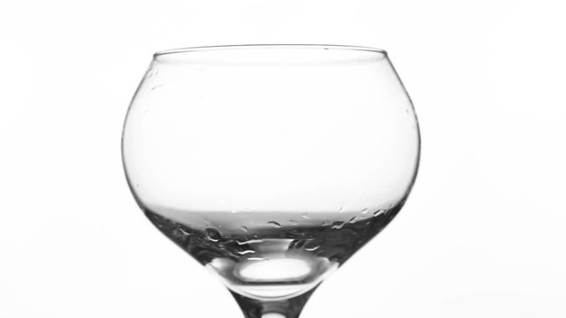 Water pour into glass on white