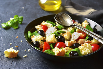 Italian salad panzanella with chicken and lamb`s lettuce.