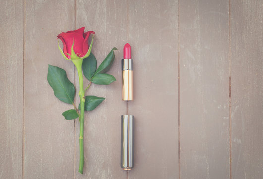 Still life with fresh rose flower and red lipstick, retro toned