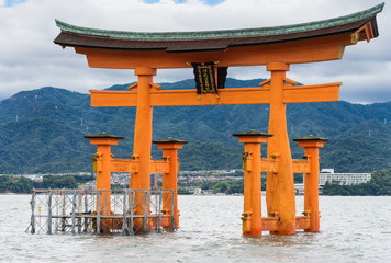 Hiroshima, Japan - September 20, 2016: Iconic historic vermilion Torii in front of Itsukushima...
