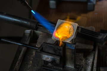 Metal Casting from Crucible to Metal Mold with blowtorch; Goldsmith Workshop; Close-up - obrazy, fototapety, plakaty